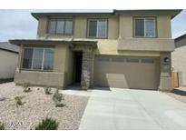 Two-story home with a two car garage, landscaped front yard, and neutral color palette at 37568 W Patterson St, Maricopa, AZ 85138