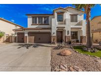 Charming two-story home with a three car garage, desert landscaping, and inviting curb appeal at 45247 W Jack Rabbit Trl, Maricopa, AZ 85139