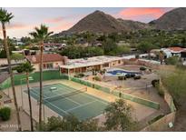 Expansive backyard with private pool, tennis court, and mountain views in this lovely estate at 4744 E Foothill Dr, Paradise Valley, AZ 85253