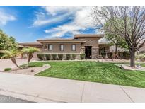 Beautiful front yard featuring a manicured lawn, desert landscaping, and a charming, modern exterior at 5291 S Bradshaw Pl, Chandler, AZ 85249