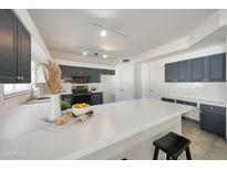 Bright kitchen features white countertops and stylish gray cabinets for a modern, inviting space at 11832 E Clinton St, Scottsdale, AZ 85259