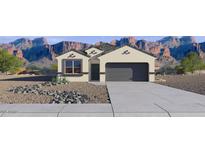 Inviting single-story home with desert landscaping and a two-car garage against a mountain backdrop at 1360 W Hess Ave, Coolidge, AZ 85128