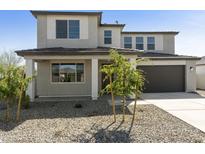 Charming two-story home featuring a low maintenance yard, covered porch, and an attached two-car garage at 15683 W Christy Dr, Surprise, AZ 85379