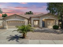 Charming single-story home with a two-car garage, desert landscaping, and a cozy front porch at 21192 E Stirrup St, Queen Creek, AZ 85142