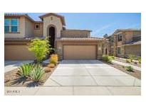 Charming townhome featuring a private garage and well-maintained landscaping for an inviting curb appeal at 2425 W Bronco Butte Trl # 2028, Phoenix, AZ 85085