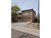 Two-story home features neutral stucco, tile roof, two car garage and desert landscaping at 2514 W Big Oak St, Phoenix, AZ 85085