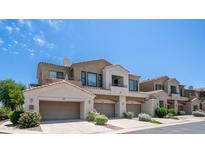 Attractive townhome featuring desert landscaping, attached garages, and a private balcony at 3131 E Legacy Dr # 2055, Phoenix, AZ 85042
