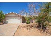 Charming single-story home with a well-maintained front yard and a two car garage at 3136 W Voltaire Ave, Phoenix, AZ 85029