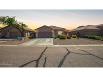 Charming single-story home featuring desert landscaping and a two-car garage at 34463 N Karan Swiss Cir, San Tan Valley, AZ 85143