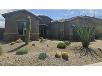 Charming home featuring desert landscaping, including cacti and drought-tolerant plants at 5637 E Lonesome Trl, Cave Creek, AZ 85331