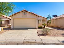 Charming single-story home with a well-maintained lawn and a two-car garage on a clear day at 8339 W Elm St, Phoenix, AZ 85037