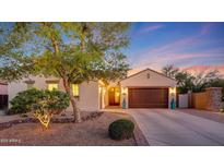 Charming home featuring manicured landscaping, a two-car garage, and a welcoming entrance at 16229 W Berkeley Rd, Goodyear, AZ 85395
