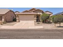 Charming single-level home featuring a two-car garage and desert landscaping at 17244 W Mohave St, Goodyear, AZ 85338