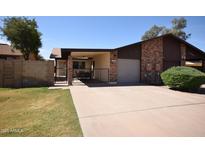 Charming single-story home with a private, gated front patio and an attached one-car garage at 1905 E Inverness Ave, Mesa, AZ 85204