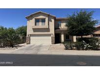 Charming two-story home featuring a two-car garage, desert landscaping, and a welcoming front porch at 20426 N Alma Dr, Maricopa, AZ 85138
