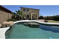 Gorgeous swimming pool and patio area in a lush, green backyard. Great for outdoor entertaining at 20426 N Alma Dr, Maricopa, AZ 85138