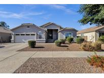 Charming single-story home featuring desert landscaping and a two-car garage in a well-maintained community at 21616 E Calle De Flores --, Queen Creek, AZ 85142