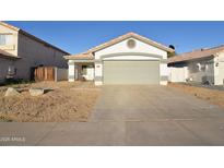 Charming single-story home with a two-car garage and low-maintenance desert landscaping at 2667 S 156Th Ave, Goodyear, AZ 85338
