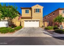 Inviting two-story home with a two car garage, manicured landscaping, and warm curb appeal at 3231 S Mingus Dr, Chandler, AZ 85286