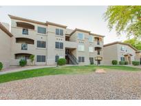 Multi-story apartment building featuring stucco siding, private balconies, and well-maintained landscaping at 3236 E Chandler Blvd # 3031, Phoenix, AZ 85048