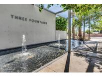 Stunning water feature with 'THREE FOUNTAINS' inscribed on the wall, surrounded by lush greenery at 4411 N 40Th St # 59, Phoenix, AZ 85018