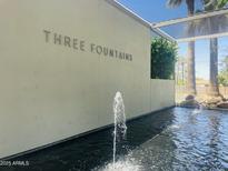 A tranquil water feature at Three Fountains with palm trees, creating a serene and inviting atmosphere at 4411 N 40Th St # 59, Phoenix, AZ 85018