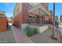 Charming brick townhome with covered front porch and attractive landscaping at 625 S Roosevelt St, Tempe, AZ 85281