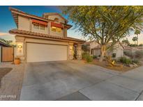 Charming two-story home with a tile roof, attached garage, and a desert-landscaped front yard and driveway at 6841 S Roosevelt St, Tempe, AZ 85283