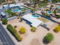 Expansive property featuring a pool, ample parking, and a unique modern home design in a sunny locale at 7667 E Cactus Rd, Scottsdale, AZ 85260