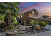 Charming two-story home with well-manicured landscaping, inviting curb appeal, and a beautiful desert sunset at 768 E Mountain Sky Ave, Phoenix, AZ 85048