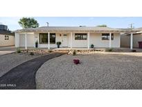 Charming single-story home with a desert landscape and a welcoming covered porch at 8524 E Mariposa Dr, Scottsdale, AZ 85251