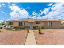 Charming single-story home with a well-manicured front yard and inviting entrance at 8602 N 27Th Ave, Phoenix, AZ 85051