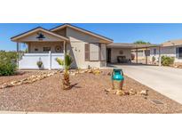 Charming single-story home featuring decorative rock landscaping and a covered carport at 8840 E Sunland Ave # 137, Mesa, AZ 85208