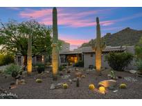 Desert-landscaped home showcasing a charming desert exterior with mature cacti and a beautiful sunset backdrop at 11398 E Desert Vista Rd, Scottsdale, AZ 85255