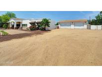 Charming single-story home featuring a rustic facade and spacious front yard at 12210 N 67Th St, Scottsdale, AZ 85254