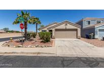 Charming single-story home featuring a two-car garage and low maintenance desert landscaping at 12438 W Flores Dr, El Mirage, AZ 85335