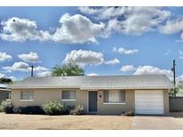 Charming single-story home with a neutral brick facade, well-maintained landscaping, and attached garage at 1309 W 10Th St, Tempe, AZ 85281
