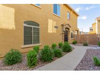 Charming two-story home featuring a landscaped yard and well-maintained exterior at 1350 S Greenfield Rd # 1040, Mesa, AZ 85206