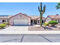 Charming single-story home with desert landscaping and a two-car garage, under a clear blue sky at 15161 W Cactus Ridge Way, Surprise, AZ 85374
