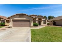 Charming single-Gathering home featuring a well-maintained lawn and a two-car garage at 2244 E Rawhide St, Gilbert, AZ 85296