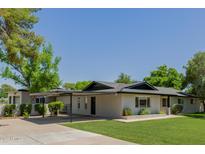 Charming single-story home with a covered parking and a well-manicured lawn at 2350 E Melrose St, Gilbert, AZ 85297