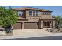 Inviting two-story home with a three-car garage and desert landscaping at 26062 W Potter Dr, Buckeye, AZ 85396