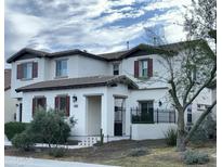 Charming two-story home with brown trim, desert landscaping, and a gated front porch at 31156 N 137Th Ln, Peoria, AZ 85383