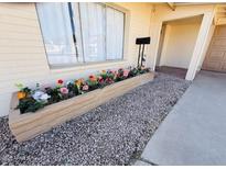 Home exterior with a flower bed featuring colorful flowers and a porch at 4517 S Grandview Ave, Tempe, AZ 85282