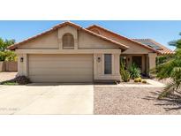 Charming single-story home featuring a two-car garage, desert landscaping, and a tile roof at 556 W Sagebrush St, Gilbert, AZ 85233