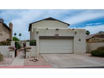 This charming home boasts a two-car garage and a stucco exterior, perfect for desert living at 630 E Jensen St # 116, Mesa, AZ 85203