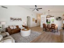 Inviting living room features stylish furnishings, open layout to dining, and modern decor accents at 9143 W Kings Ave, Peoria, AZ 85382