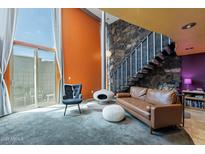 Inviting living room featuring a unique fireplace, stone staircase, and modern design at 1123 E Maryland Ave # 4, Phoenix, AZ 85014