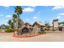 Inviting condominium community entrance with stone signage, tropical landscaping, and well-maintained exterior at 14145 N 92Nd St # 1084, Scottsdale, AZ 85260