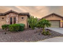 Desert landscaping highlights this charming single Gathering home with a two car garage at 20558 N 263Rd Dr, Buckeye, AZ 85396